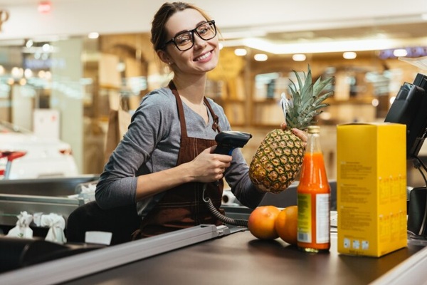 happy-female-cashier-scanning-grocery-items_171337-2418.jpg